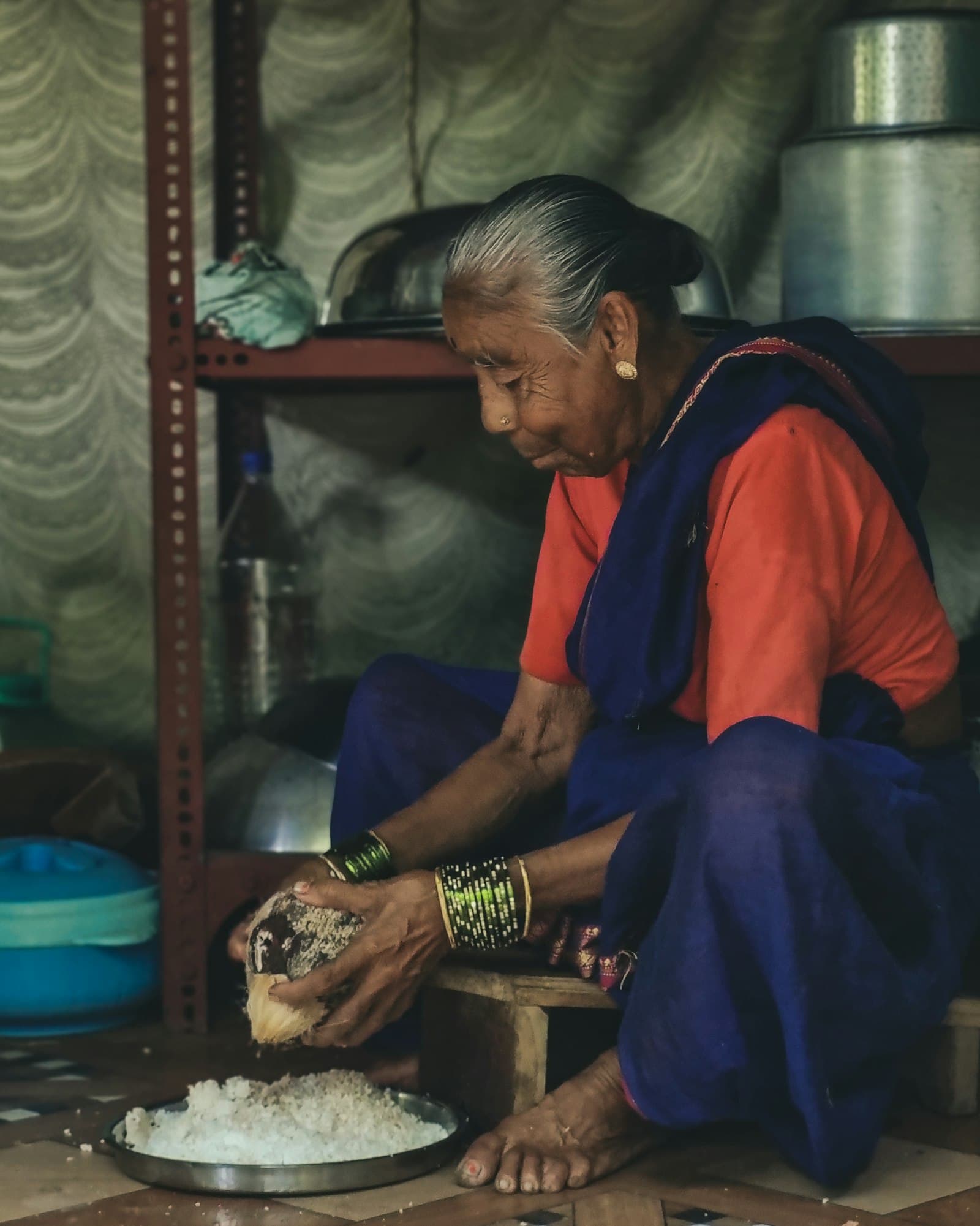 An elderly woman preparing food in her home kitchen
